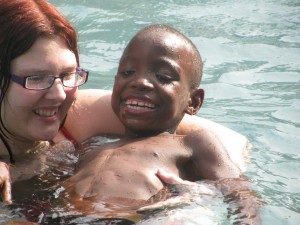 Emmy supporting a boy with a diability from Letaba school